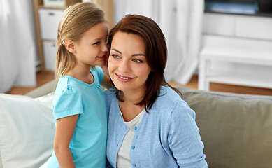 Image showing daughter whispering secret to mother at home