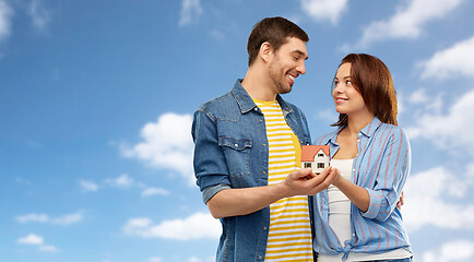 Image showing smiling couple holding house model