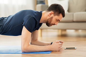 Image showing man doing plank exercise at home