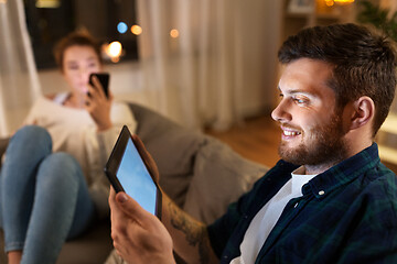 Image showing couple with tablet computer and smartphone at home