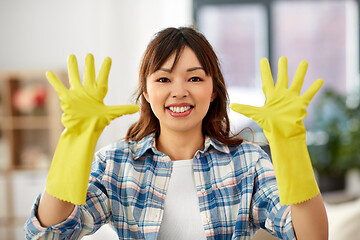 Image showing asian woman in rubber gloves cleaning at home