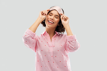 Image showing happy young woman in pajama and eye sleeping mask