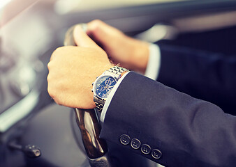 Image showing senior businessman hands driving car