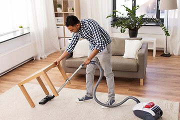 Image showing indian man with vacuum cleaner at home