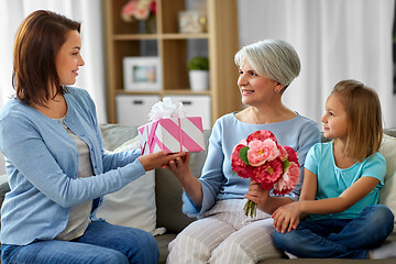 Image showing female family giving present to grandmother