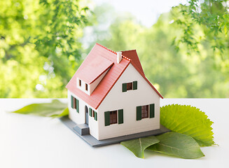 Image showing close up of house model and green leaves