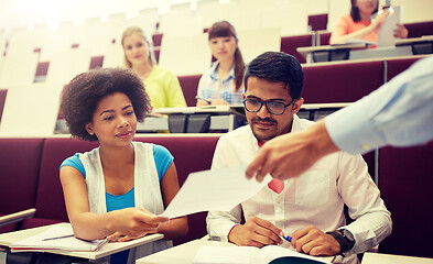 Image showing teacher giving tests to students at lecture