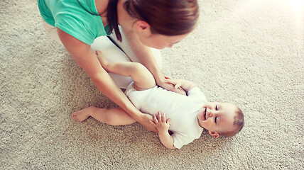 Image showing happy mother playing with baby at home