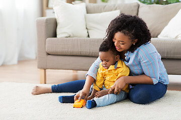 Image showing mother and baby playing with toy car at home