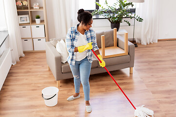 Image showing african woman or housewife cleaning floor at home