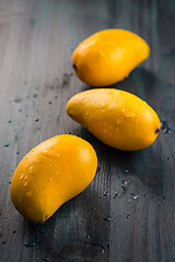 Image showing Fresh honey mango fruits on wooden background