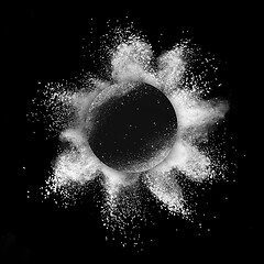 Image showing White powder explosion in a round frame on a black background.