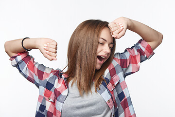 Image showing Portrait of a casual teen girl yawning