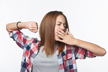 Image showing Portrait of a casual teen girl yawning