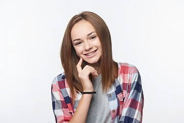 Image showing Smiling relaxed teen girl looking at camera