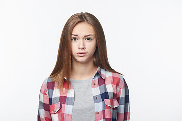 Image showing Discontent confused teen girl looking at camera