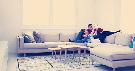 Image showing couple relaxing at  home with tablet computers