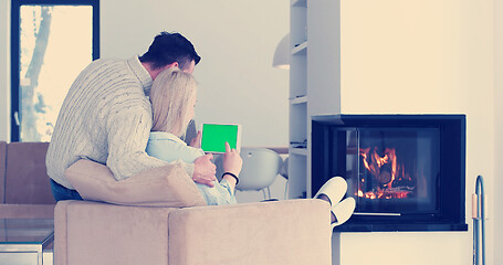 Image showing couple relaxing at  home with tablet computers