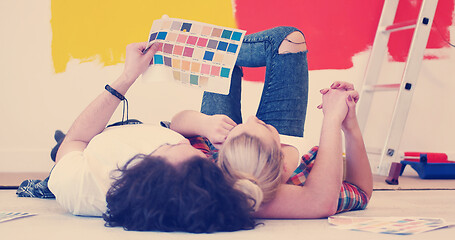 Image showing Happy young couple relaxing after painting