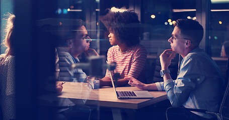 Image showing Multiethnic startup business team in night office