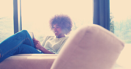 Image showing african american woman at home using digital tablet