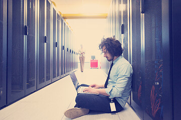 Image showing Team of young technicians working together on servers