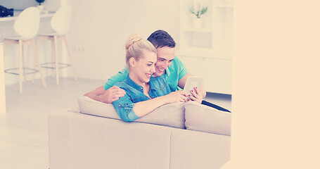 Image showing couple relaxing at  home with tablet computers