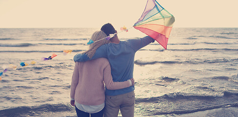 Image showing Happy couple having fun with kite on beach