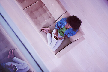 Image showing african american woman at home with digital tablet top view