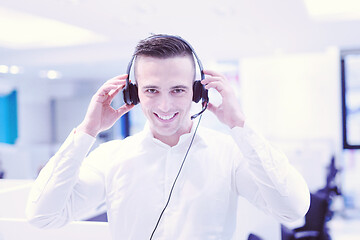 Image showing male call centre operator doing his job