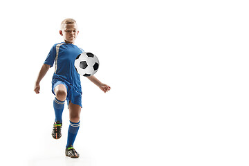 Image showing Young boy with soccer ball doing flying kick