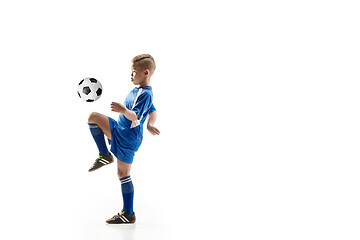 Image showing Young boy with soccer ball doing flying kick