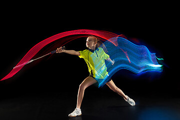 Image showing one caucasian young teenager girl woman playing Badminton player on black background