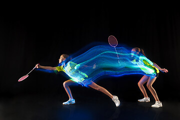 Image showing one caucasian young teenager girl woman playing Badminton player on black background