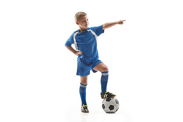 Image showing Young fit boy with soccer ball standing isolated on white