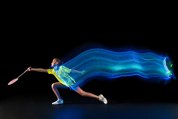 Image showing one caucasian young teenager girl woman playing Badminton player on black background