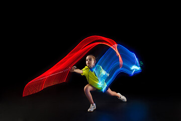 Image showing one caucasian young teenager girl woman playing Badminton player on black background