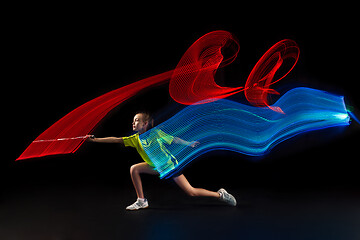 Image showing one caucasian young teenager girl woman playing Badminton player on black background