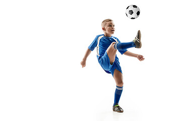 Image showing Young boy with soccer ball doing flying kick