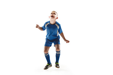 Image showing Young boy with soccer ball doing flying kick