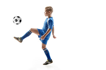 Image showing Young boy with soccer ball doing flying kick