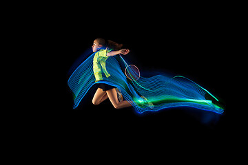 Image showing one caucasian young teenager girl woman playing Badminton player on black background