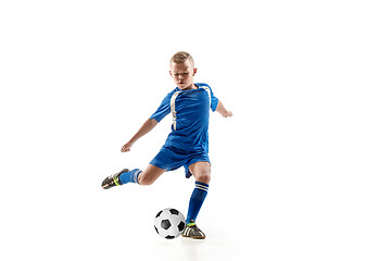 Image showing Young boy with soccer ball doing flying kick