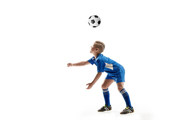 Image showing Young boy with soccer ball doing flying kick