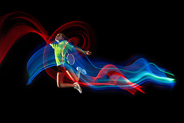 Image showing one caucasian young teenager girl woman playing Badminton player on black background