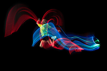 Image showing one caucasian young teenager girl woman playing Badminton player on black background