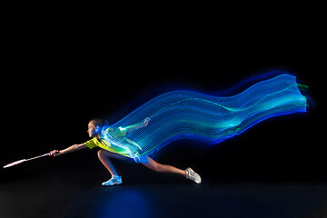 Image showing one caucasian young teenager girl woman playing Badminton player on black background