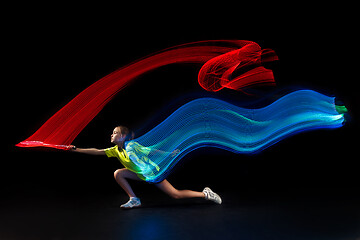 Image showing one caucasian young teenager girl woman playing Badminton player on black background