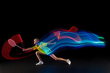 Image showing one caucasian young teenager girl woman playing Badminton player on black background