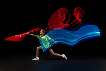 Image showing one caucasian young teenager girl woman playing Badminton player on black background